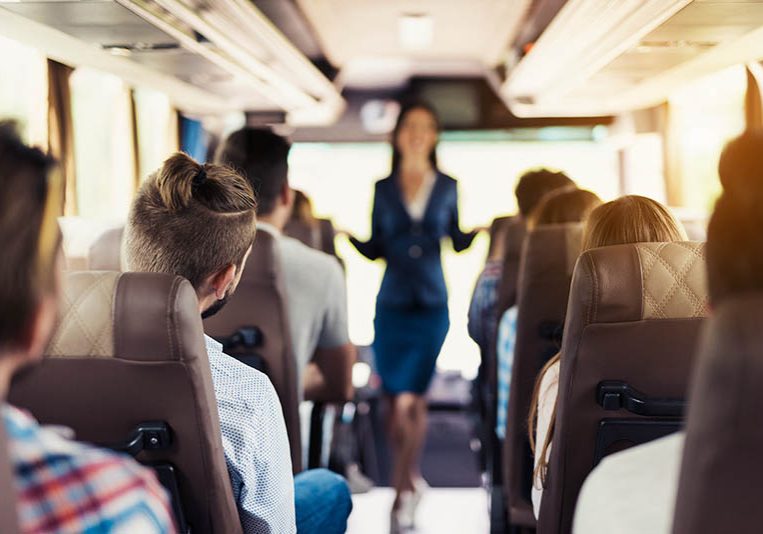 Bus Attendant in Uniform and Happy Passengers. Bus Attendant in Uniform and Happy Passengers.